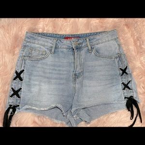 Guess denim shorts with black ties on each side.